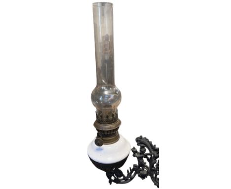 A Victorian oil lamp and cast iron wall bracket, 40 cm excluding bracket 