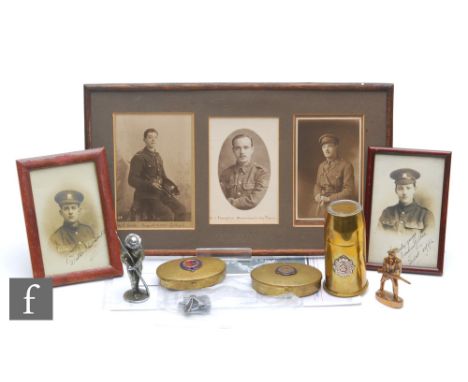 A large brass World War One trench lighter also signed photographs of young officers, two miniature models of soldiers, two b