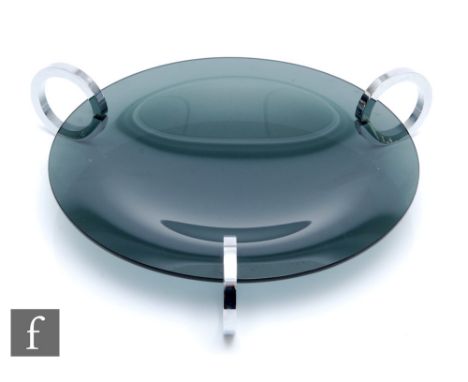 A 20th Century smoke glass bowl in the Art Deco style, the shallow circular bowl supported by three chrome plated rings, unma