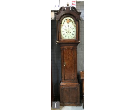 An early 19th Century oak longcase clock with an eight-day movement, the 12 inch broken arch moonphase dial with subsidiary s
