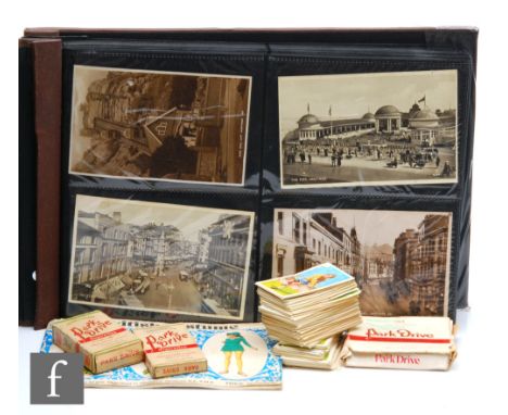 An album of over one hundred and fifty early 20th Century real photographic postcards, mainly Hastings and Sussex, but also s
