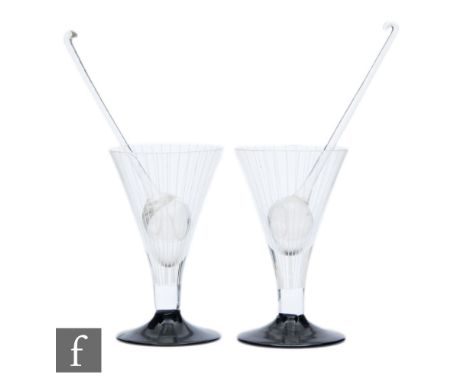 A pair of 1930s Art Deco cocktail glasses of conical form with black foot and fine white enamelled lines, together with a pai