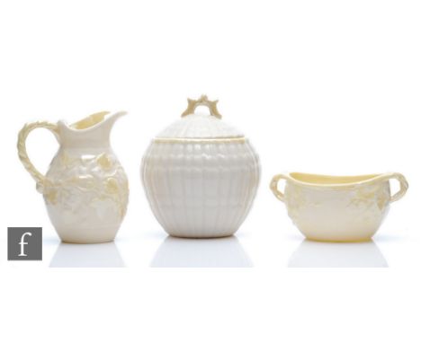 A Belleek strawberry set comprising cream jug and a sugar basin with moulded ivy leaves heightened in yellow lustre, 5th and 