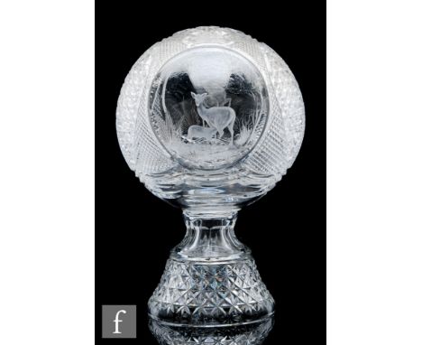 A large contemporary crystal glass table sculpture, the large spherical form on a socle type base decorated with two hand eng