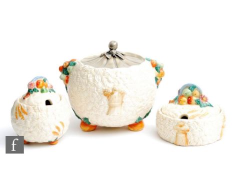 A Clarice Cliff Celtic Harvest Biscuit barrel of spherical form with bun feet, relief moulded with fruit and corn bundles pic
