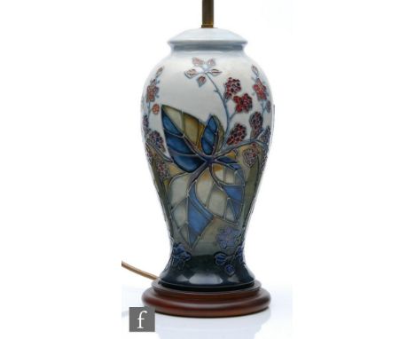 A Moorcroft Pottery table lamp decorated in the Bramble pattern designed by Sally Tuffin, marks obscured by affixed wooden pl