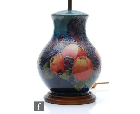 A Moorcroft Pottery table lamp decorated in the Finches pattern designed by Sally Tuffin, marks obscured by affixed wooden pl