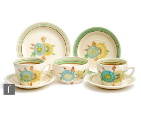 A pair of Clarice Cliff Lynton shape trios circa 1936, comprising teacup, saucer and side plate with a matched sugar bowl all