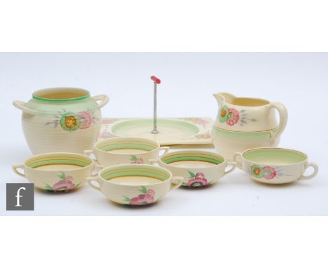 A Clarice Cliff cake stand, hand painted in the green Sundew pattern with stylised flower heads in green and pink, width 26.5