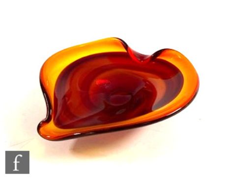 A mid Century Italian Murano Sommerso glass bowl, the shallow wide rim of stylised leaf shape, cased in deep amber over ruby,