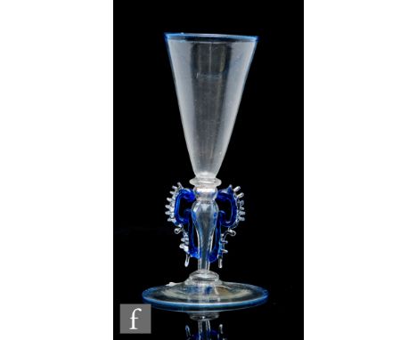 A late 19th Century Salviati winged drinking glass, the conical bowl above a hollow blown baluster form stem with applied blu