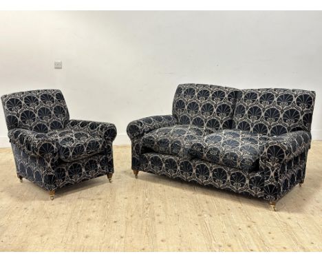 An Edwardian mahogany framed sofa and easy chair in Art Nouveau blue and grey upholstery, feather seat pads, brass caps and c