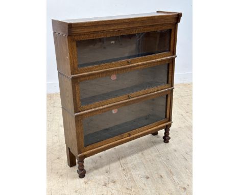 A Peter Graham, Hillhead Sectional Bookcases, Glasgow oak triple section bookcase, maker's labels present (h.106cm x l.86cm x