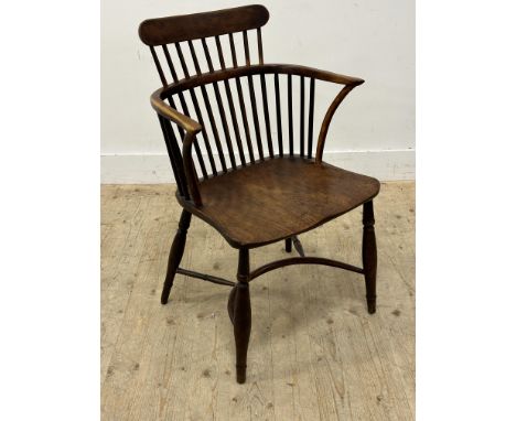 A 19thc yew and elm comb back chair with saddle seat and crinoline stretcher (legs reduced) (h.84cm)