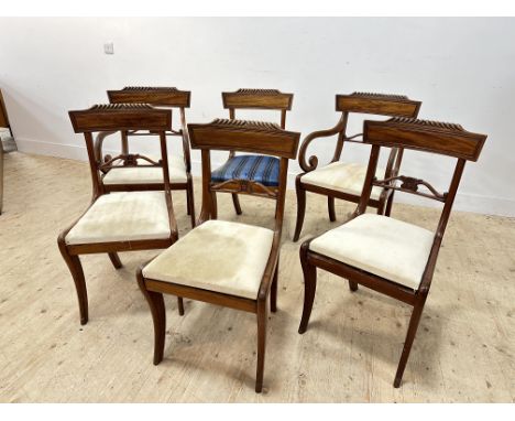 A handsome set of four plus two Regency light mahogany classical inspired dining chairs with sabre supports and drop in seats