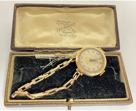 A lady's nine ct gold cased wristwatch (running), the dial having fleur de lis central section and Roman numeral indices to o