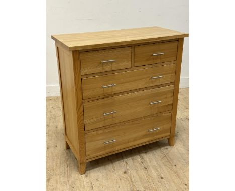 A light oak chest of drawers with brushed stainless steel bar handles (h.97cm x l.90cm x w.43cm)