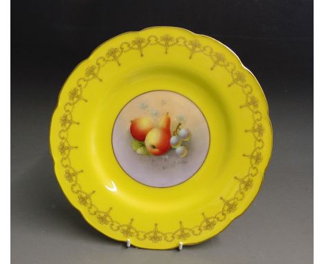 A Royal Worcester yellow ground cabinet plate with an intricate gilt border, the centre painted with fruit signed H. Ayrton, 