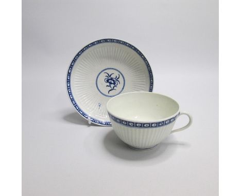 A Worcester Blue and White Ribbed Tea Cup and Saucer, painted in the centre with The Dark Sprig patternDate circa  1770-80Siz