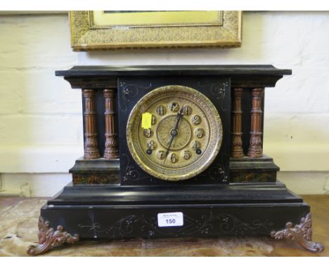 A Victorian mantel clock, imitating slate, the gilded dial over painted twin pilasters on scroll feet, the twin train movemen