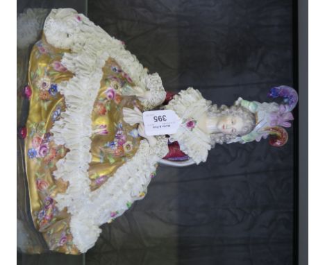 A German porcelain figure of a seated lady with exuberent lace and gold dress, 30cm high 