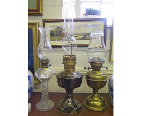 A brass oil lamp, a glass oil lamp and another oil lamp (3)