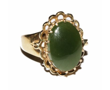 A 9 carat gold ring set with an oval cut nephrite jade stone