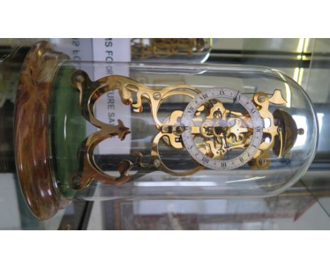 A Thwaites and Reed brass skeleton clock of scrolling form, with silvered chapter ring, Roman numerals and single train movem