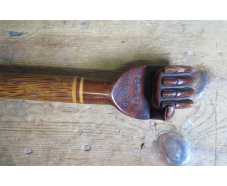 A walking stick, the handle carved in the form of a clenched fist, engraved 'Pitcairn Island'