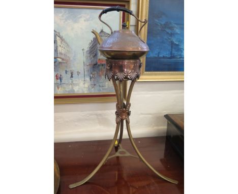 A late Victorian copper and brass kettle and stand, the hammered kettle stamped T&Co on a outswept brass tripod base, 62cm hi