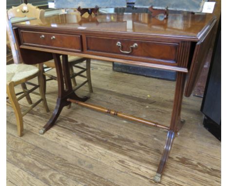 A crossbanded mahogany sofa table, with two frieze drawers on reeded downswept legs and brass lion paw feet, 100cm wide