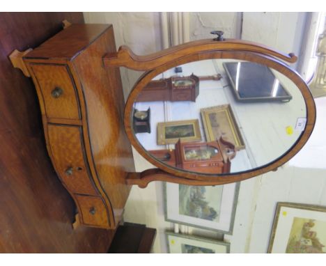 A George III style satinwood and ebony strung toilet mirror, the oval plate above a serpentine base with three drawers and og