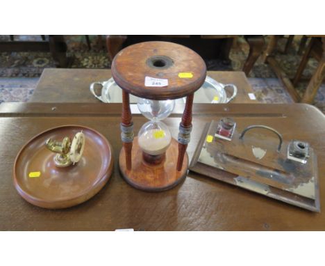 A mahogany and brass table nutcracker, in the form of a ship's wheel, 23cm diameter, a stained wood sand timer, stamped J.B. 