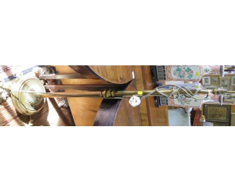 A brass standard lamp, with adjustable stem and circular platform with three feet, 113cm high