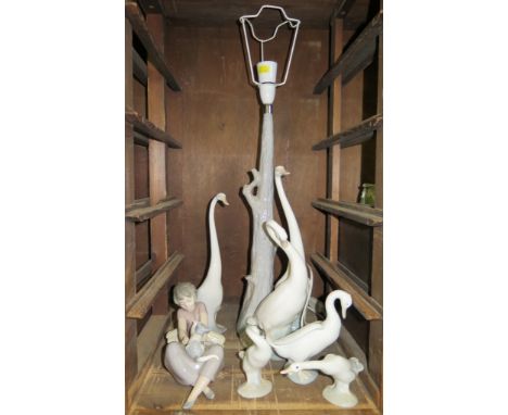 A collection of Lladro and Nao figures of swans, including a table lamp, 46cm high and a Nao figure of a girl playing with a 