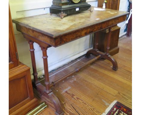 A Victorian burr walnut sofa table, stamped Gillows, with two frieze drawers on fluted supports and downswept legs, as found,