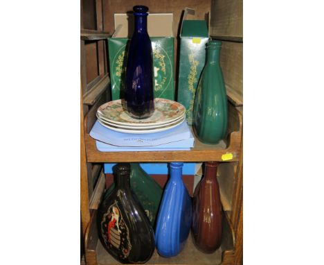 A collection of Courvoisier ceramic display flasks and three Wedgwood plates