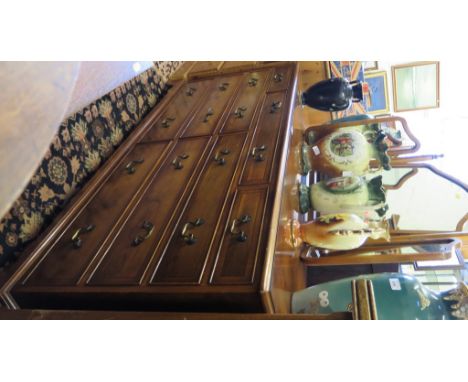 A crossbanded yew wood dressing cabinet, with triptych mirror, the cabinet with three drawers over two banks of three drawers