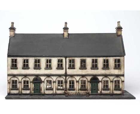 A Victorian doll's house/trunk in the form of a two house street, with a pillared facade, twenty glazed windows and hinged ro