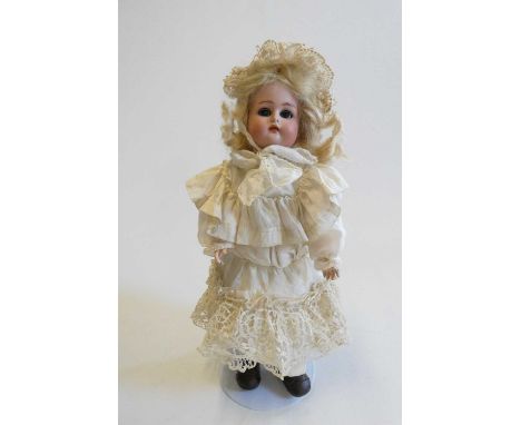 A Kammer &amp; Reinhardt bisque socket head doll with blue glass sleeping eyes, open mouth, teeth, pierced ears, blond wig, w