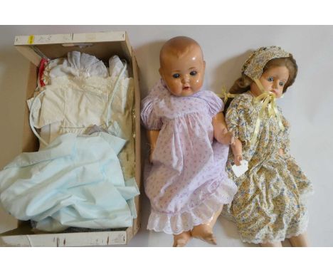 Two vintage dolls, comprising a 27" papier mache shoulder head doll, with blue glass fixed eyes, closed mouth, cloth body and