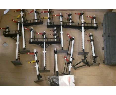 Nine well made course scale O gauge semaphore signals including single post and bracket signals and a line side coach on bloc