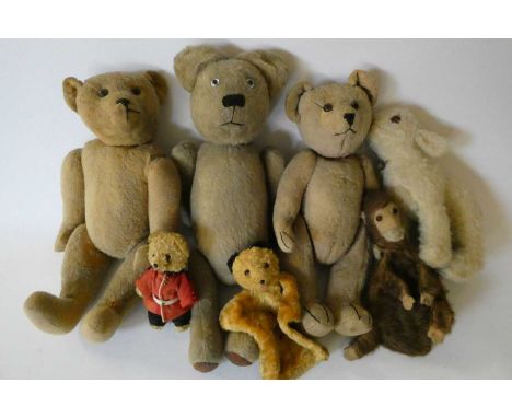 Seven vintage plush toys comprising three large teddy bears, one small soldier bear, two puppets including Sooty and a woolly