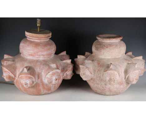 A pair of modern terracotta vases, one converted to a table lamp, both modelled with protruding faces, height 37cm, width 46c