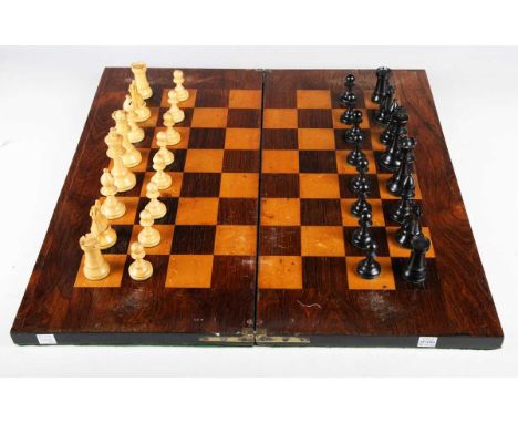 A 20th century ebony and sycamore Staunton chess set with weighted bases, height of king 9cm, boxed, together with a folding 