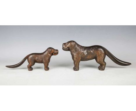 An early 20th century cast iron novelty nutcracker in the form of a dog, length 30cm, together with a smaller example.