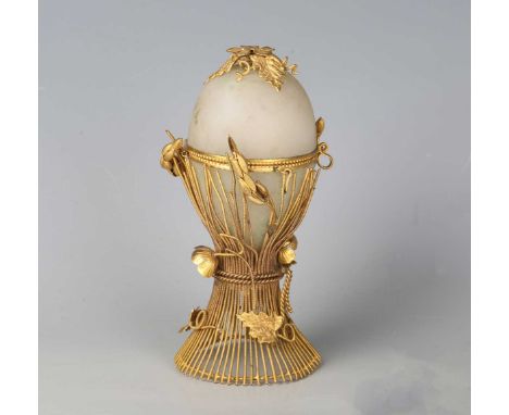 A  mid/late 19th century French gilt metal and opaline glass nécessaire, modelled in the form of an egg raised within a cagew