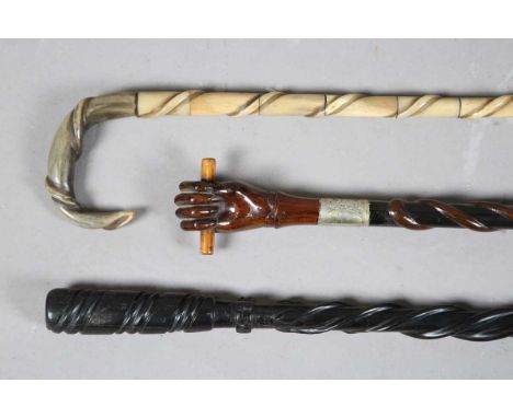 A 19th century sectional horn walking stick with spiral carved decoration, length 87cm, a late 19th century hardwood walking 