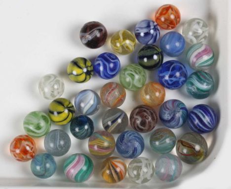 A collection of approximately thirty-five glass marbles, including some latticino examples, diameter of largest 1.7cm.