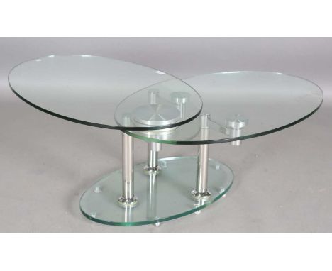 A modern Italian glass and chromium plated revolving two-tier cocktail table, possibly by Naos Furniture, the two oval synchr